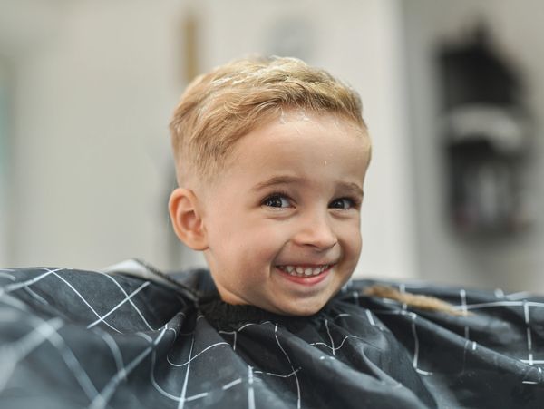 Smiling young boy with fresh haircut.