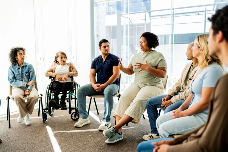 Mid adult woman talking during group therapy session