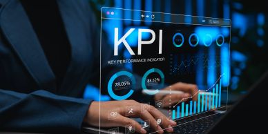 Business professional analyzing KPI data on a futuristic transparent screen.