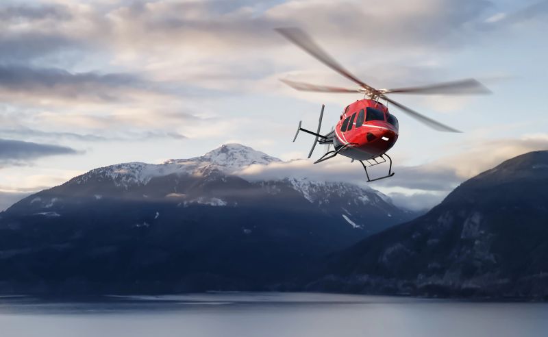 A red helicopter soars above a stunning snowy mountain range during beautiful sunset skies.  3D rendering