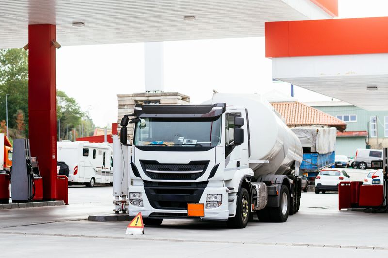 A fuel truck unloading at a gas station