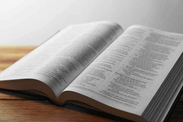 Open book on a wooden table.