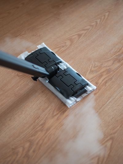 Steam mop cleaning a wood floor.