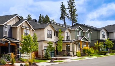 Row of modern suburban houses on a clear day.
