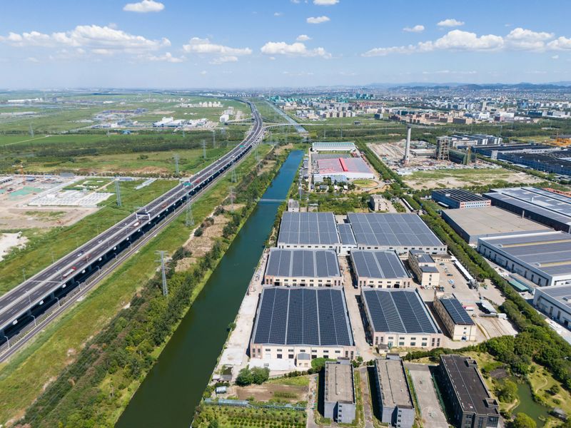 Aerial view of solar panels on the roofs of factories in an industrial area