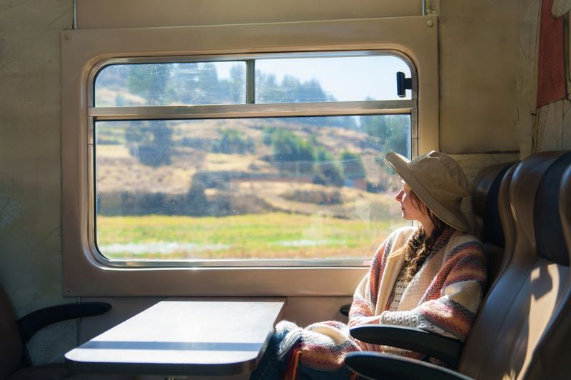 Woman taking the scenic train to Machu Picchu in Peru