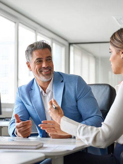 Business conversation between colleagues in an office.