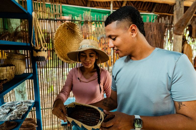 Tourists observing and learning about indigenous crafts during Curripaco tribe visit