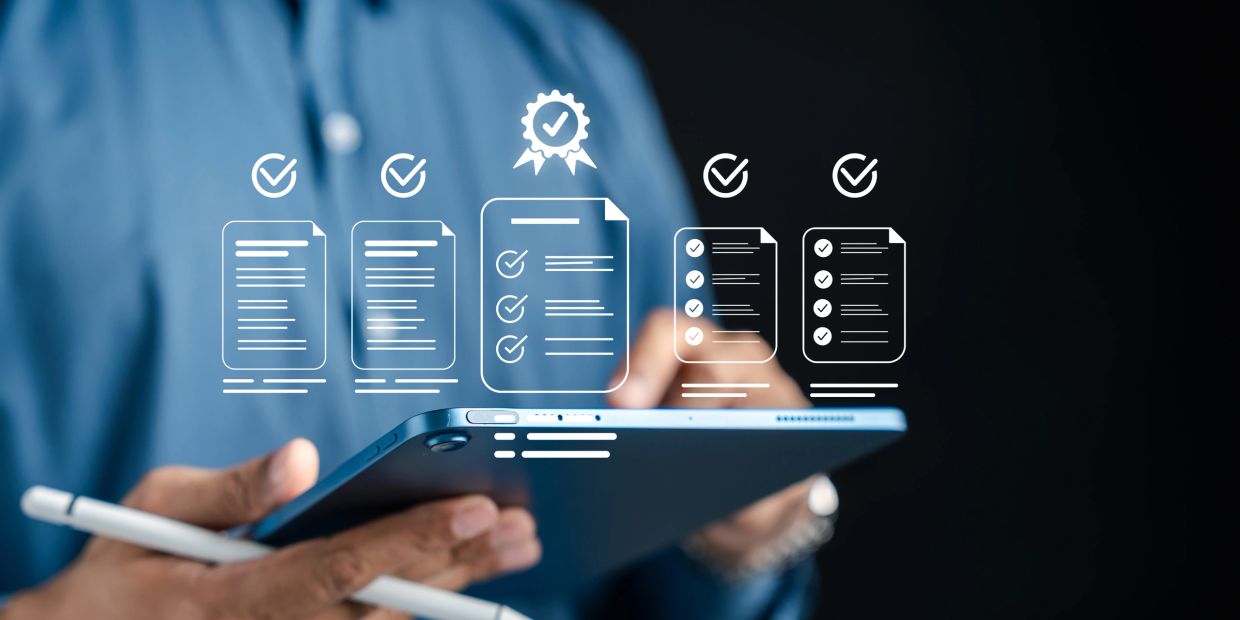 Person holding tablet with digital checklists and approval icons floating above.
