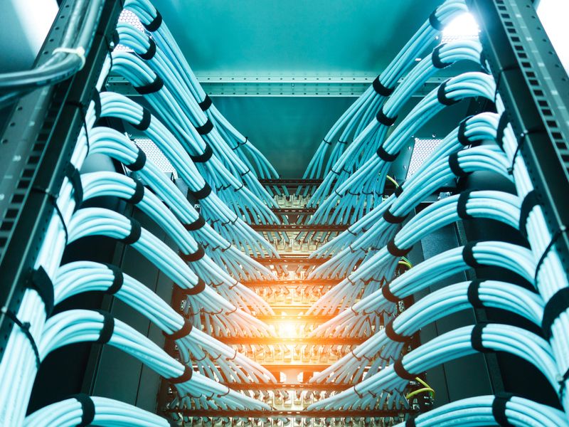 A close-up view of meticulously arranged network cables in a data center rack. The visual showcases the importance of organization in modern technology settings.