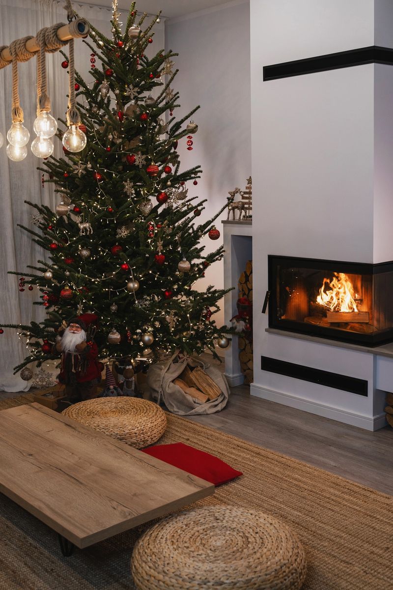 Festive Living Room Decorated for Christmas with Tree and Fireplace.