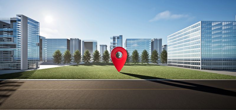 3D rendering of vacant land with pin marker. Area beside a city road with high-rise modern buildings and blue sky in background. Represents high value and demand in real estate and property markets.