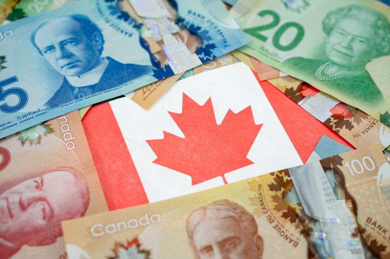 Close up of Canadian flag on dollar banknotes.