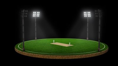 Illuminated baseball field under night lights.