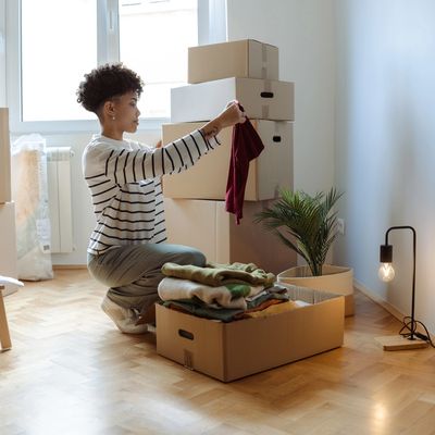 Woman packing clothes into boxes