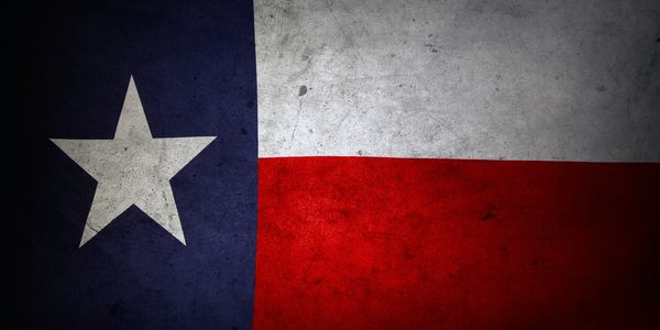 Grungy Texas state flag with a white star on blue, white, and red stripes.