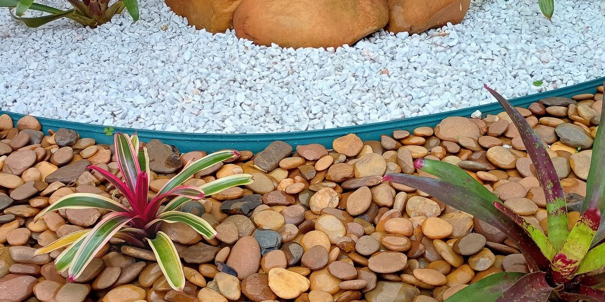 Decorative garden with colorful plants and stones in white and brown.