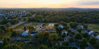 Aerial view of a suburban neighborhood at sunset.