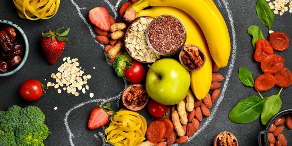 Whole foods for gut health arranged around chalk stomach drawing — functional nutrition Utah