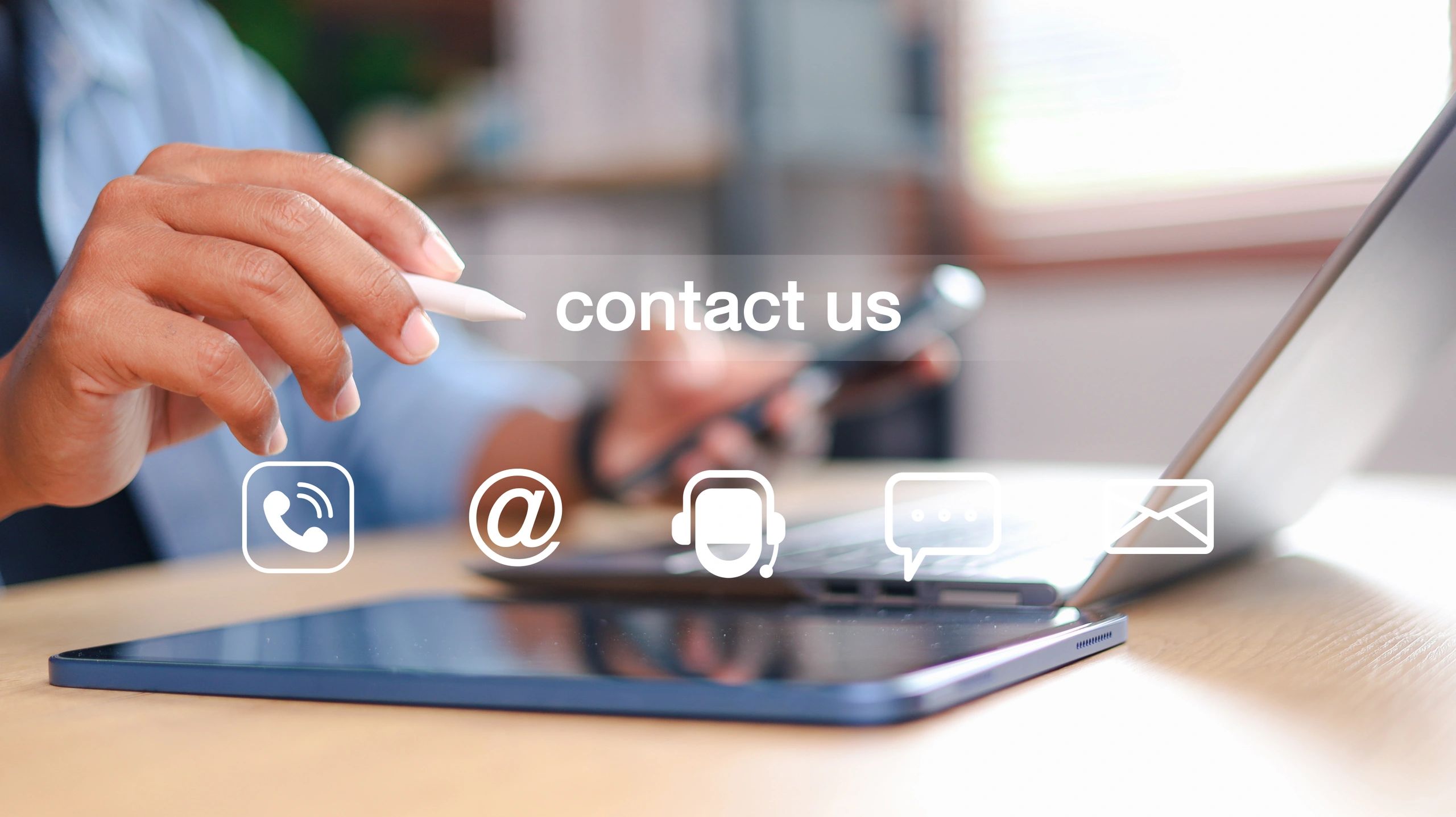 man with phone, laptop and tablet showing that you can call, email, text, or message 