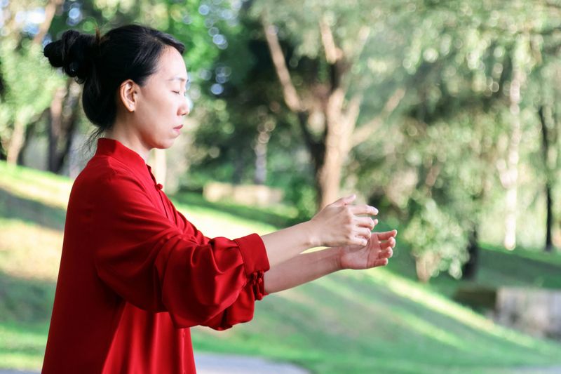 Asian woman doing Tai Chi in the park