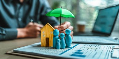 Hand protecting house and family figures with umbrella.