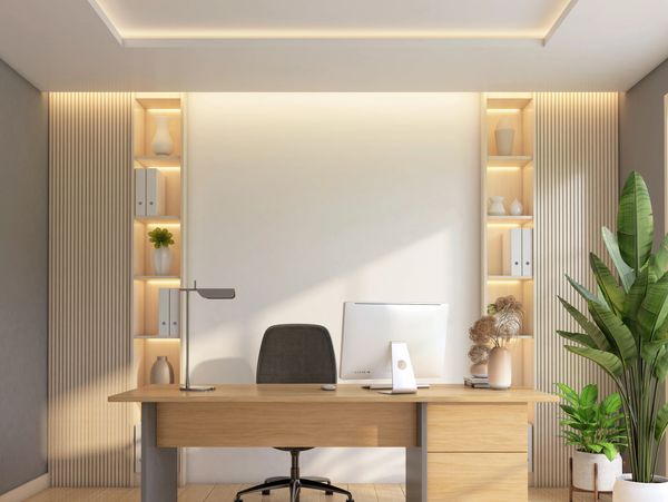 Minimalist modern office setup with wooden desk and plants.