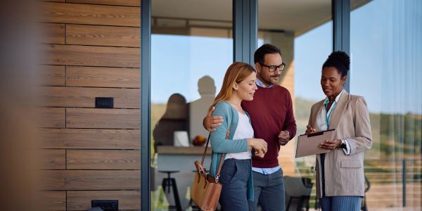 Couple viewing home with real estate agent.
