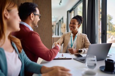 Business handshake in office meeting.