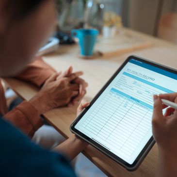 Person reviewing a digital medical record on a tablet.