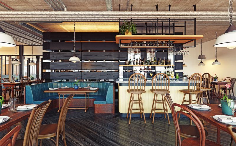 Modern restaurant and bar interior with industrial design. Empty dining room with wooden furniture and exposed ceiling. 3D rendering of a contemporary pub or cafe.