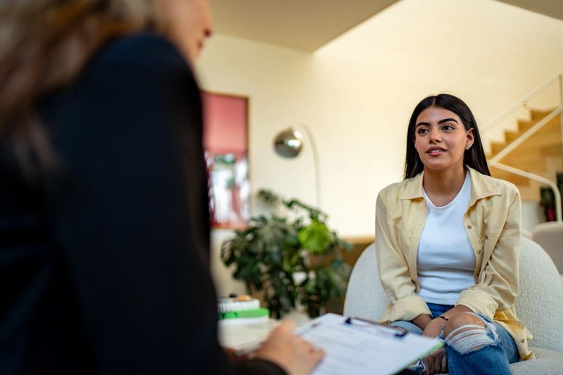 Teenage girl talking to psychotherapist