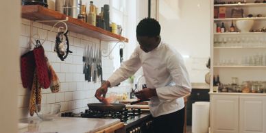 Chef preparing food in a kitchen.