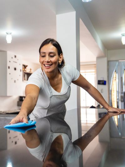 Woman polishing a dark countertop