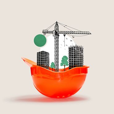 Orange construction helmet with city buildings, crane, and trees inside symbolizing urban development.