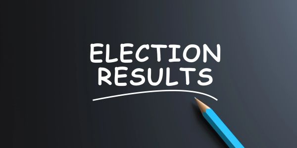 Text 'ELECTION RESULTS' underlined by a blue pencil on a dark background.