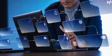 Person interacting with virtual social media icons on laptop.