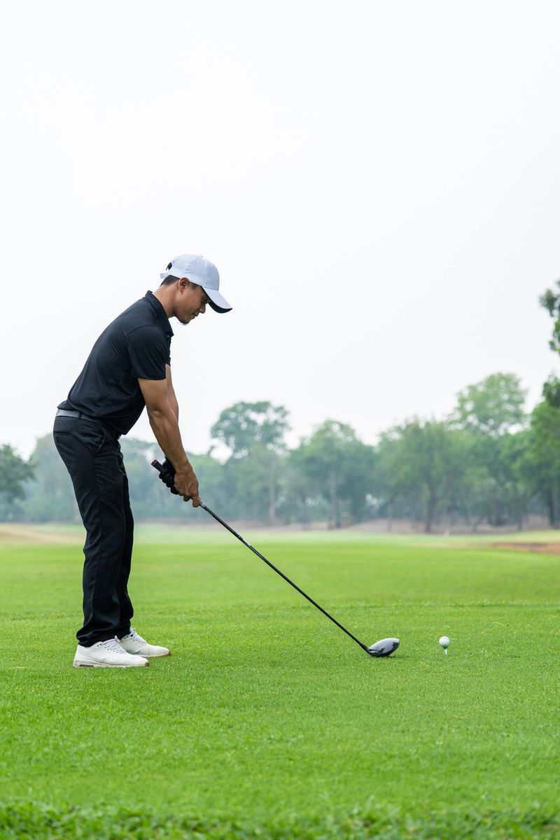 Professional young male golfer swings his club on scenic golf course. Attractive sportsman enjoy outdoor recreation with light exercise and sport lifestyle while playing golf at course grounds.