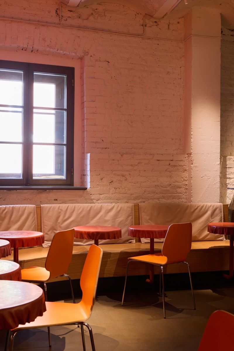 A vibrant caf interior featuring colorful chairs and inviting tables, ideal for social gatherings