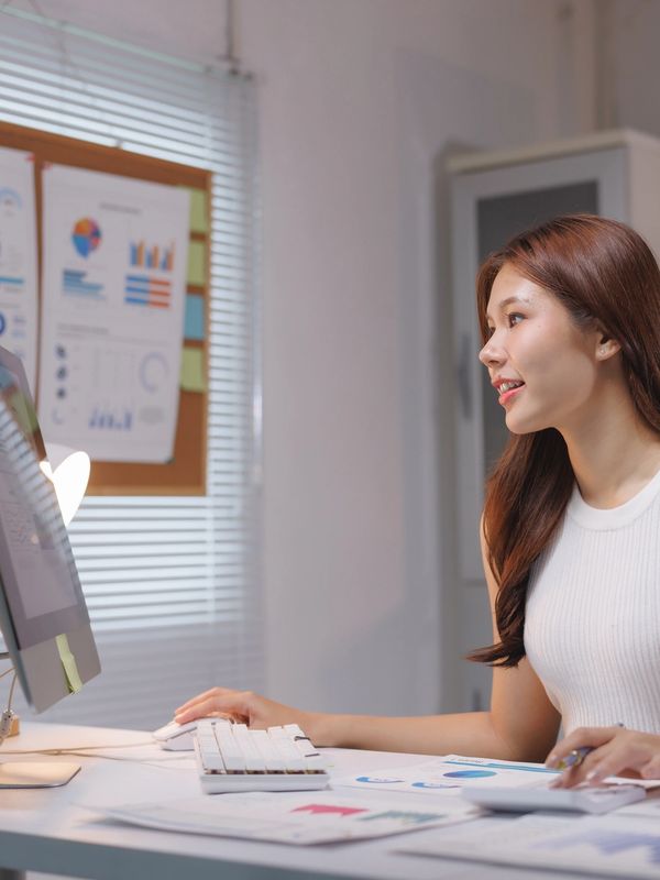 Woman working on computer in office.