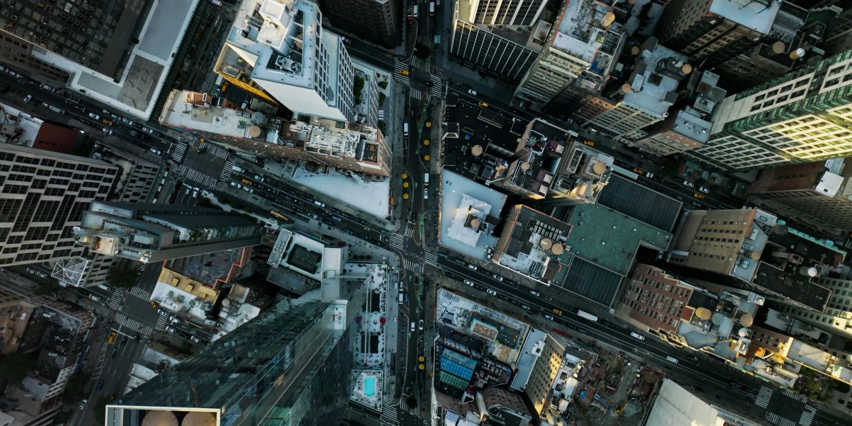 Aerial view of busy city streets and tall buildings.