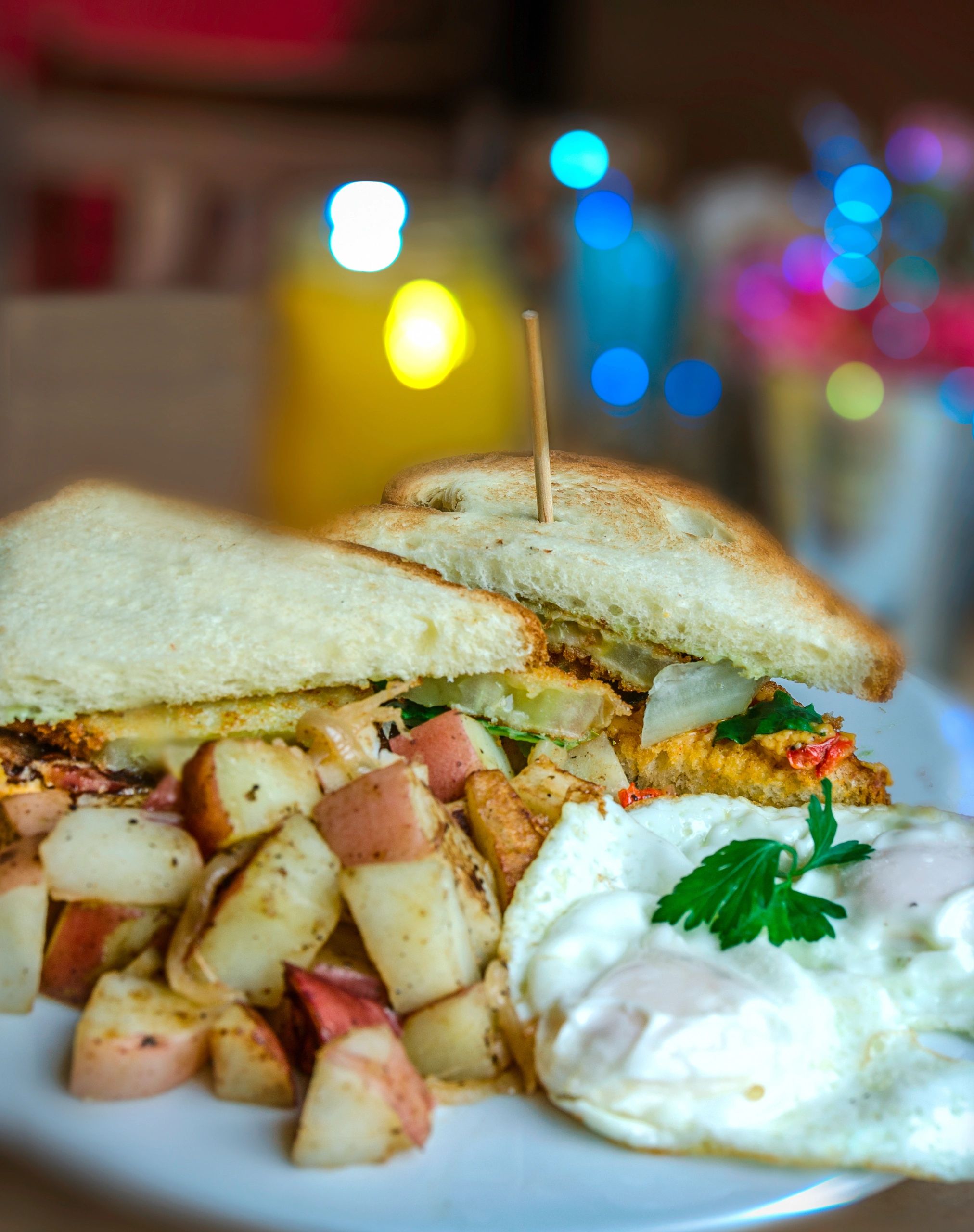 Sandwich with potatoes and eggs on a plate.