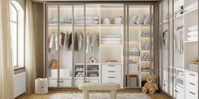 Modern walk-in closet with glass doors and organized storage.