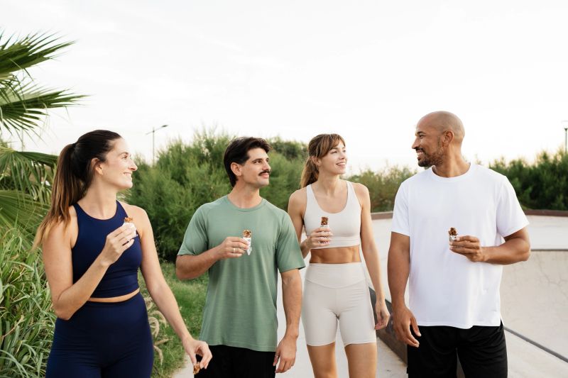 Friends enjoying healthy snack after workout outdoors