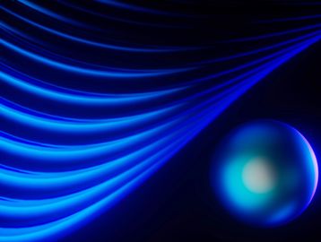 Abstract blue waves flowing towards a glowing blue sphere on a dark background.
