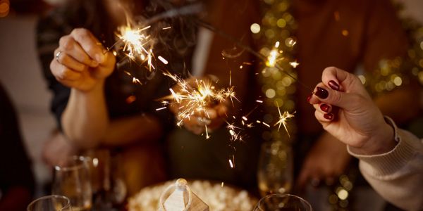 People holding sparklers at a celebration.