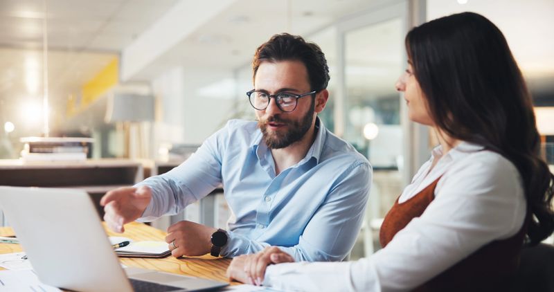 Team, business people and discussion on laptop in office, planning or insurance policy at night. Computer, meeting or broker talk for project, development or proposal for premium coverage on overtime