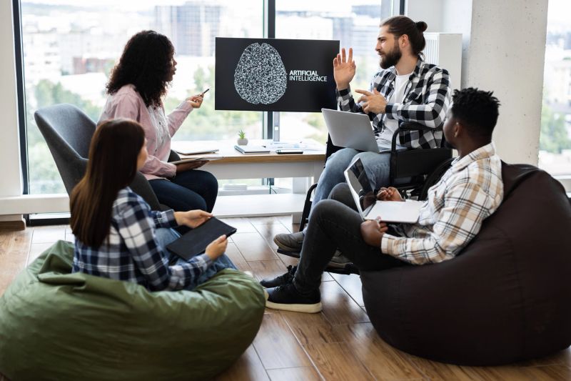Meeting of diverse group discussing artificial intelligence development, featuring young professionals sharing ideas in contemporary workspace. Inclusive environment showcasing teamwork, technology.