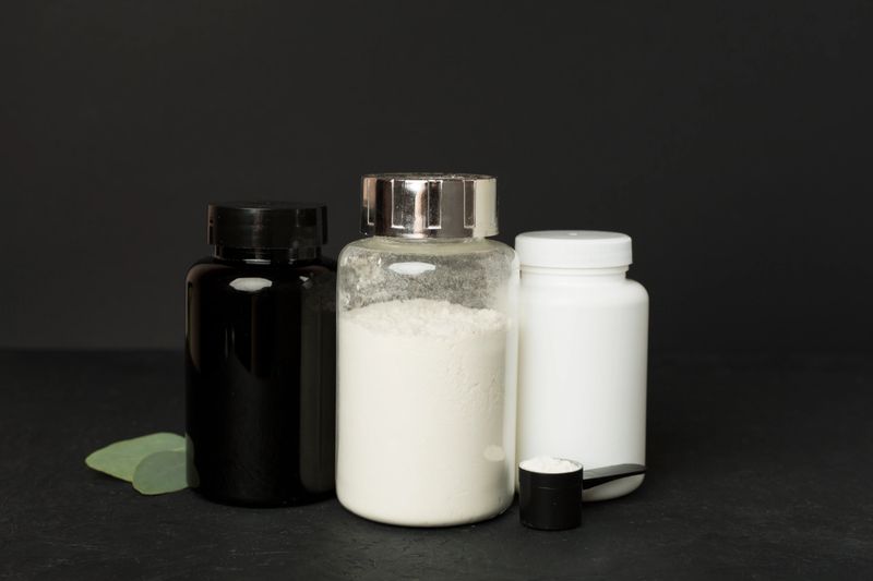 Jar with protein powder on concrete background. Sports nutrition concept
