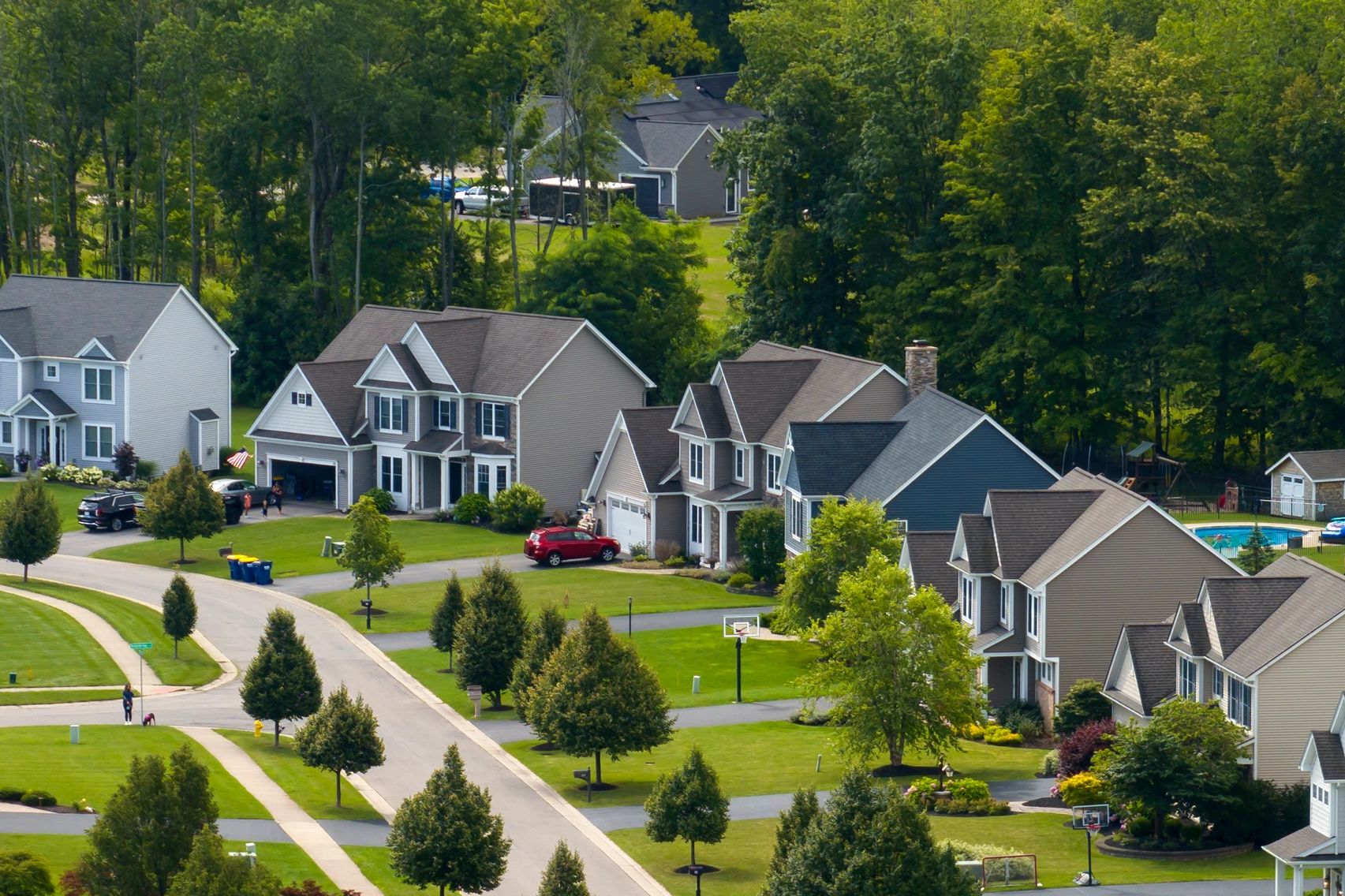 Suburban neighborhood with houses, greenery, and streets.